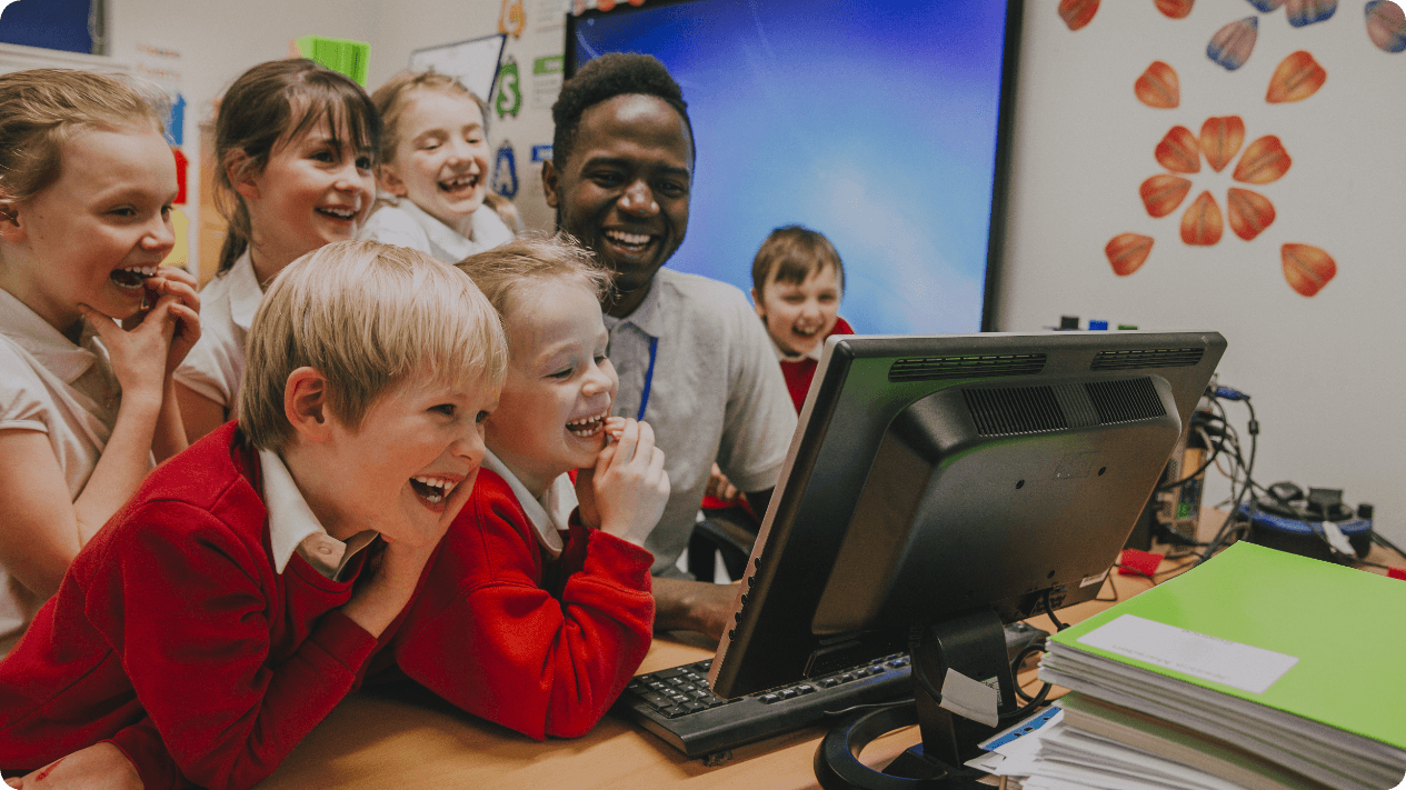 Computer science teacher in a classroom with elementary school children
